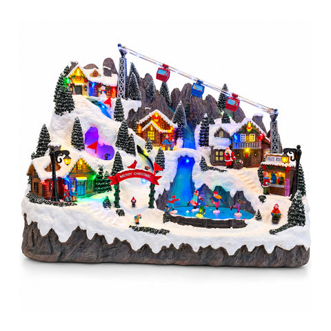 Illuminated Christmas Village with Moving Ski and Skating Rinks, LED Lights and Music – 56x37x42 cm