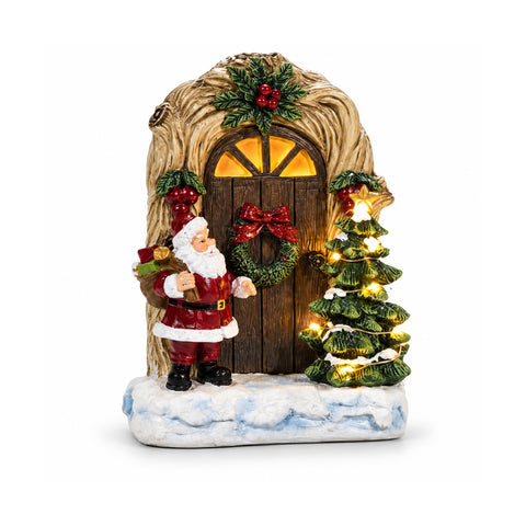 Battery-powered light-up Santa Claus with door and little tree, H19 cm